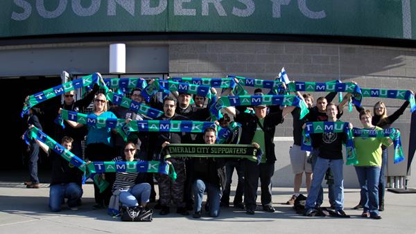 A group of Emerald City Supporters with TamU-K scarfs